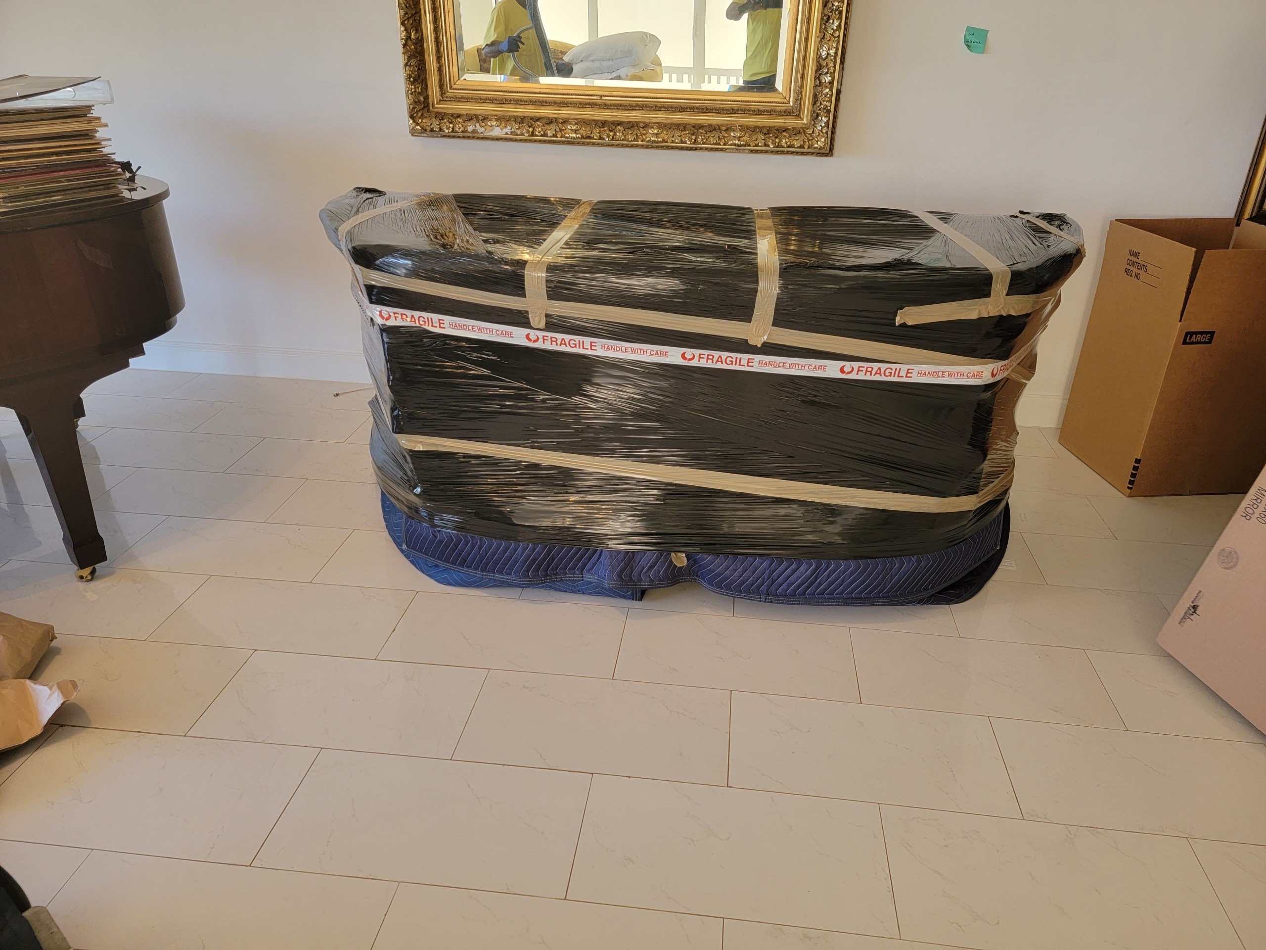 Hall's Local Movers carefully wrapping and protecting specialty items for transport